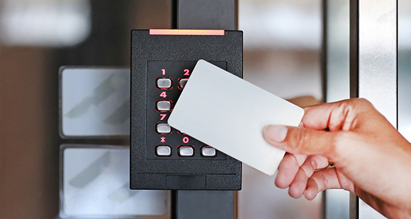 a person using a keycard to access a keypad access system
