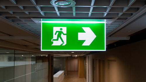 an emergency lighting sign illuminating a hallway