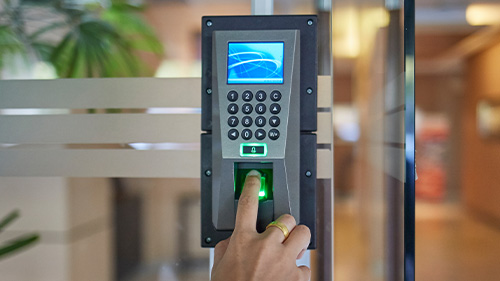 a person using their fingerprint to access and access system with a keypad